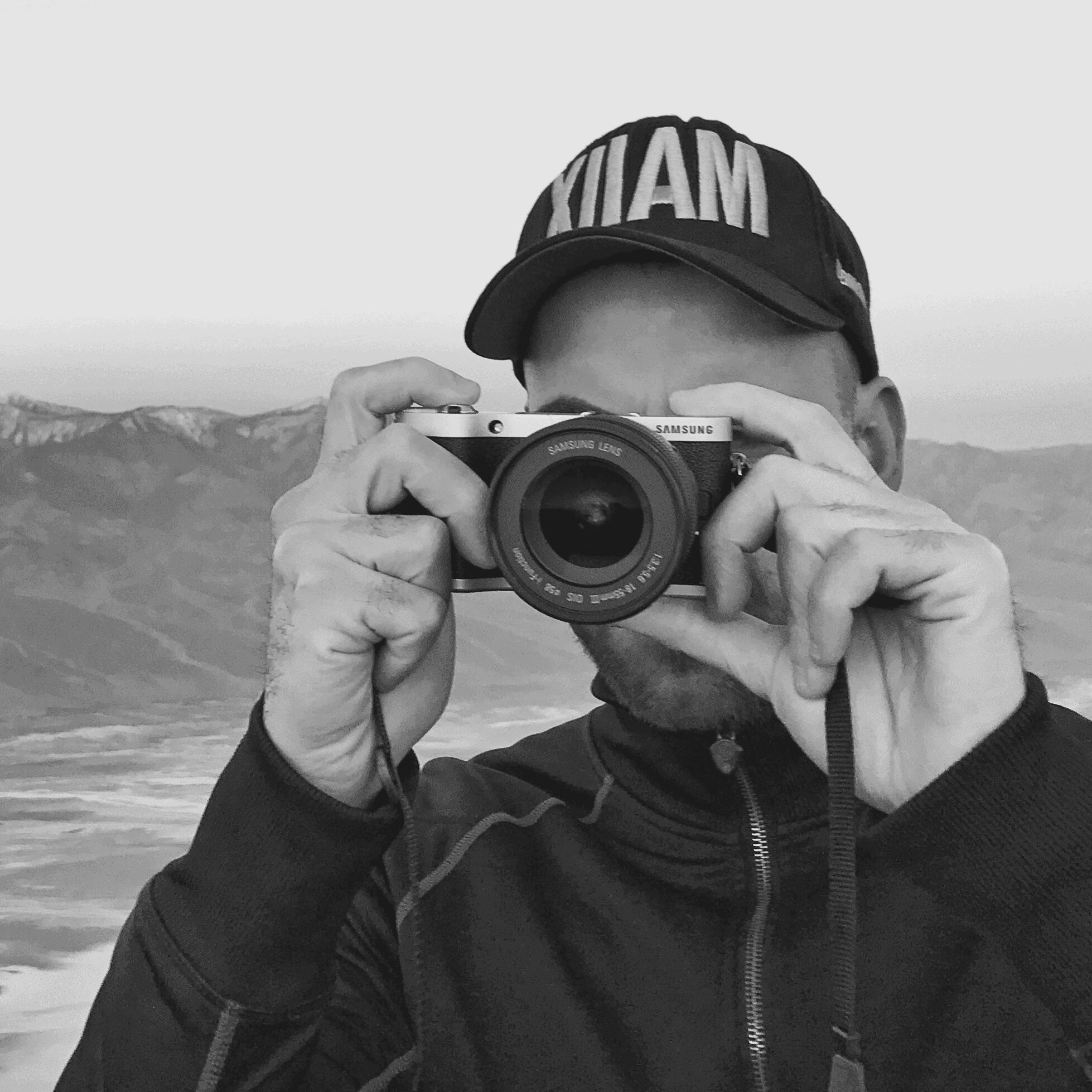 Oscar Rivas holding a camera up to his face